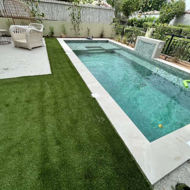 Artificial Grass Attached To The Side Of The Pool With Ceramic Tiles - Elixir: Your Perfect Choice For Swimming Pool Tiles And Synthetic Grass In Dubai, UAE