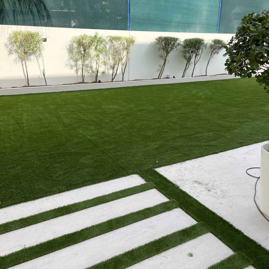 Villa's Outdoor Area Enhanced With A Combination Of Artificial Grass And Outdoor Tiles - Creating A Beautiful Landscape