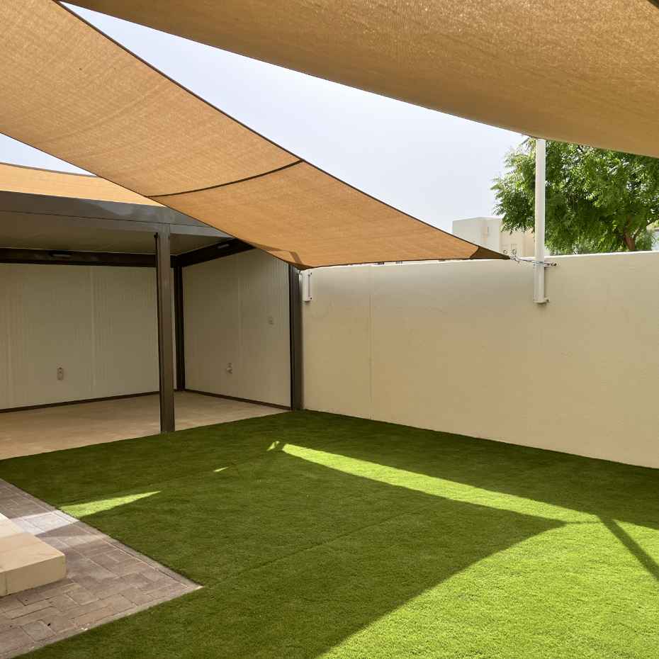 The Villa's Outdoor Space Transformed With Fake Grass, Creating A Beautiful Landscape