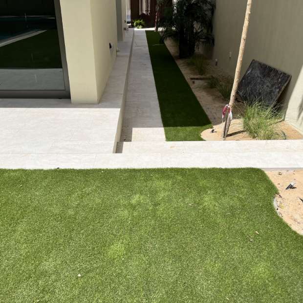 Artificial Grass Garden with Curved Tiles Pavement - A Beautiful Synthetic Lawn in Dubai