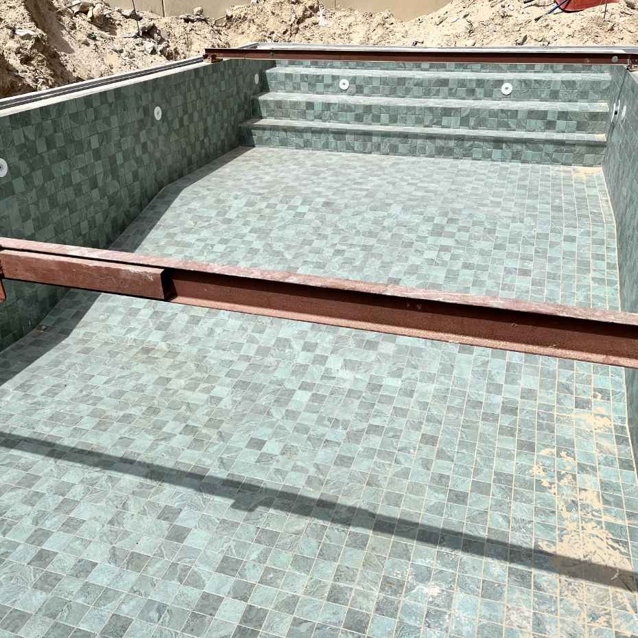 Swimming Pool under construction with Alpine Green 100 x 100 mosaic Pool tile
