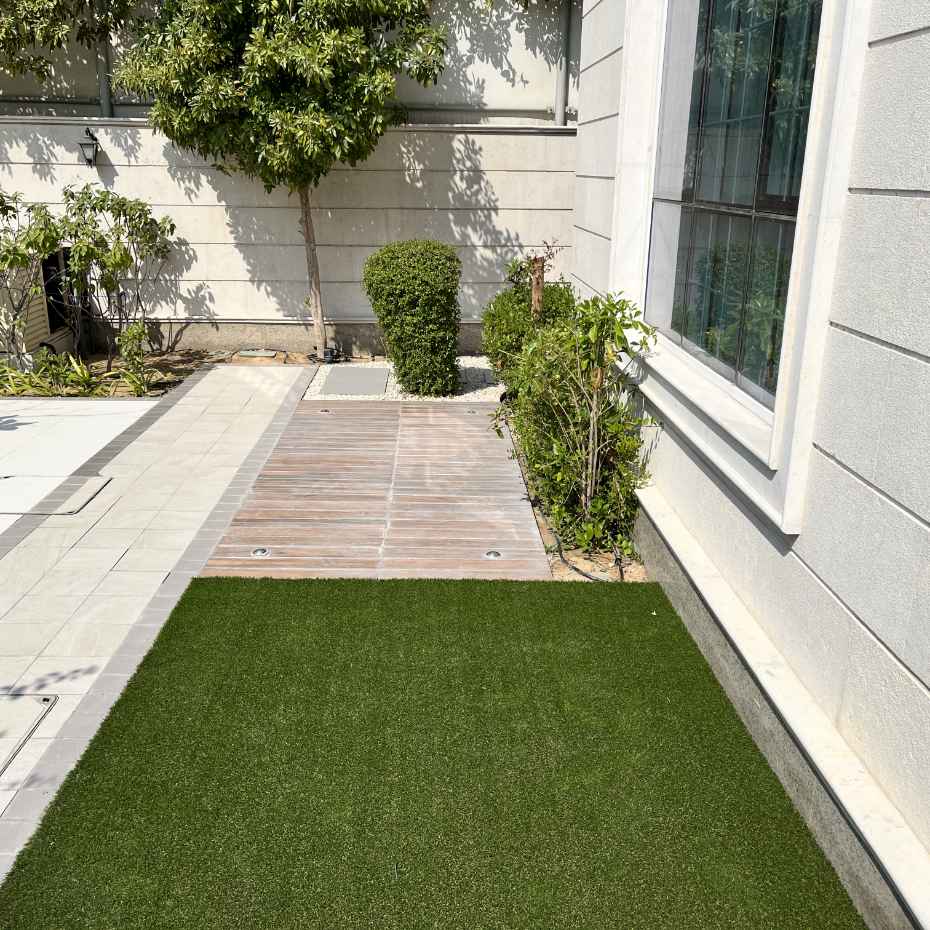 Artificial Grass Carpet Laid Outdoors Attached To House Creating A Green Aesthetic