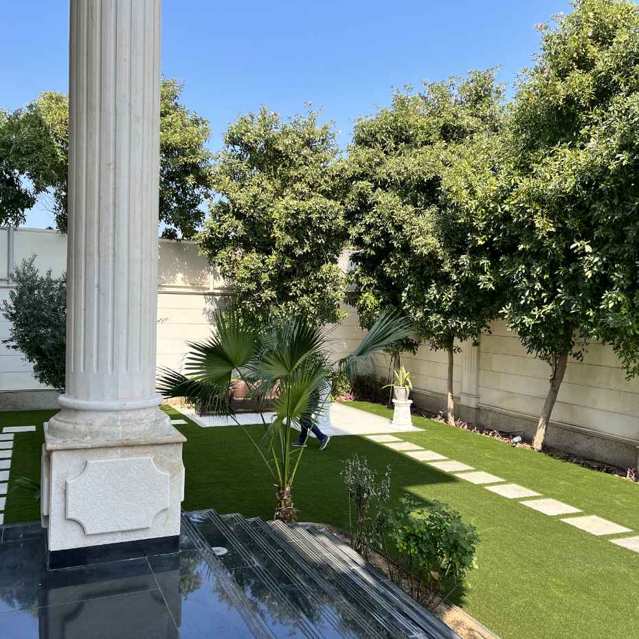 Outdoors With Artificial Grass And A Single Tile Walkway Create An Elegant Look With A Natural Aesthetic.