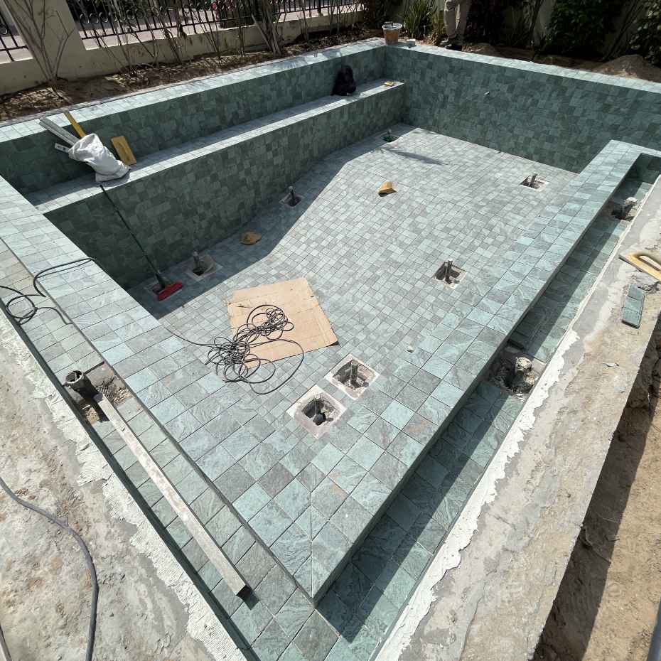 Outdoor Swimming Pool Under Construction Using Alpine Green 100x100 Mosaic Pool Tiles