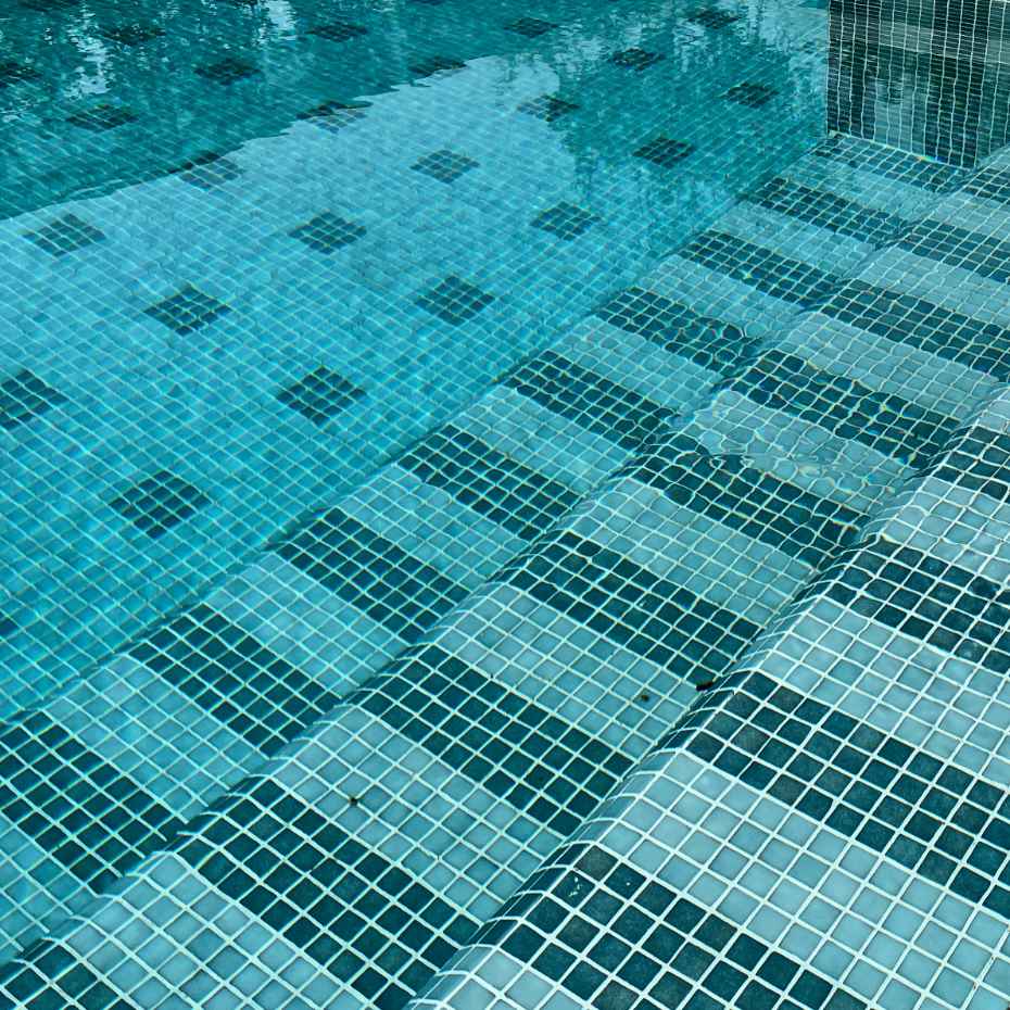 Front View Of A Swimming Pool With EGM-201 Light Green Glass Mosaic Pool Tile.