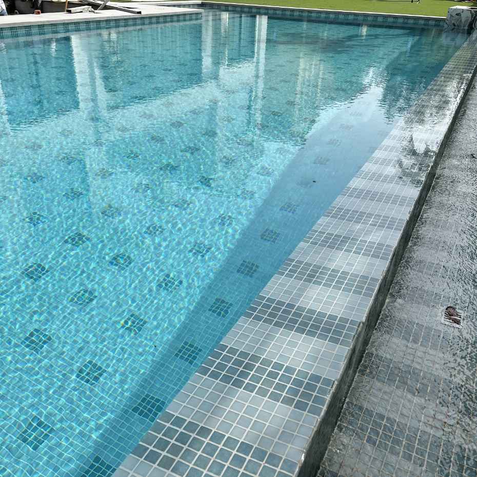 Diagonal View Of A Clear Swimming Pool With EGM-201 Light Green Glass Mosaic Pool Tiles