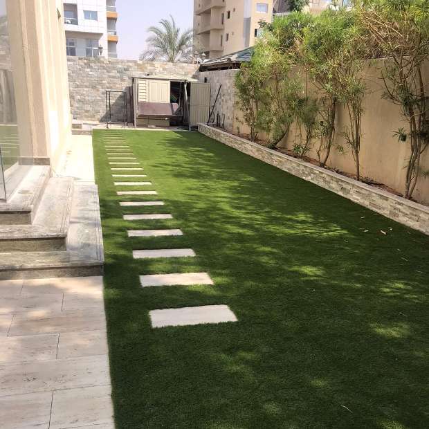 The Outdoor Area with Garden Featuring Elegant Fake Grass | Elixir - Your Ideal Solution for Synthetic Grass in Dubai