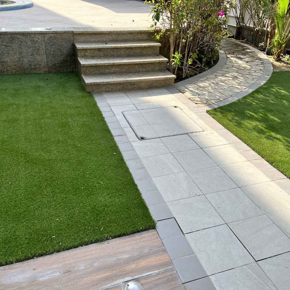 The Artificial Grass On Either Side Of The Walkway Enhances Its Appearance.