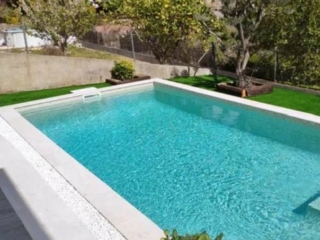 A private pool adorned with Elixir Swimming Pool Tile Mosaic