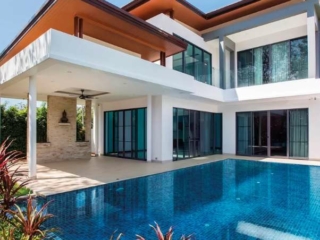 Swimming pool enhanced with Elixir's Pool Tiles in front of the house.