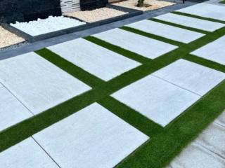 Elixir Artificial grass installed alongside paving stones, enhancing the outdoor beauty.
