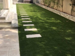 Outdoor installation of artificial grass in Dubai, UAE.