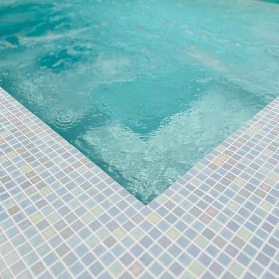 Corner View Of A Swimming Pool With EGM-Pearl 500 Mosaic Pool Tiles